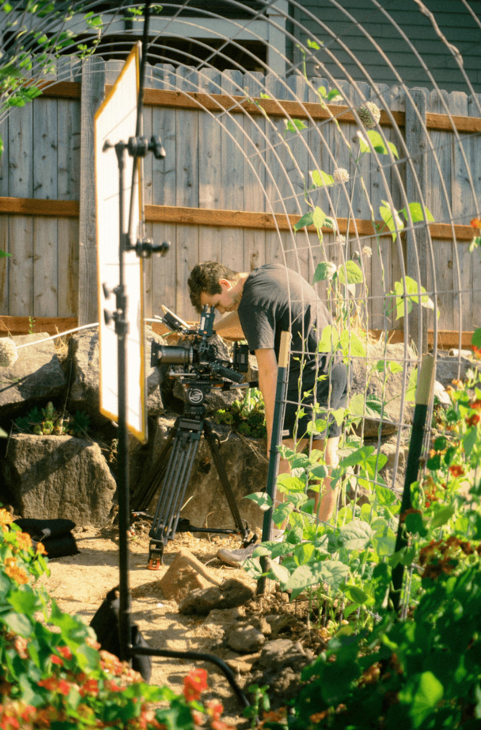 Director at camera in garden