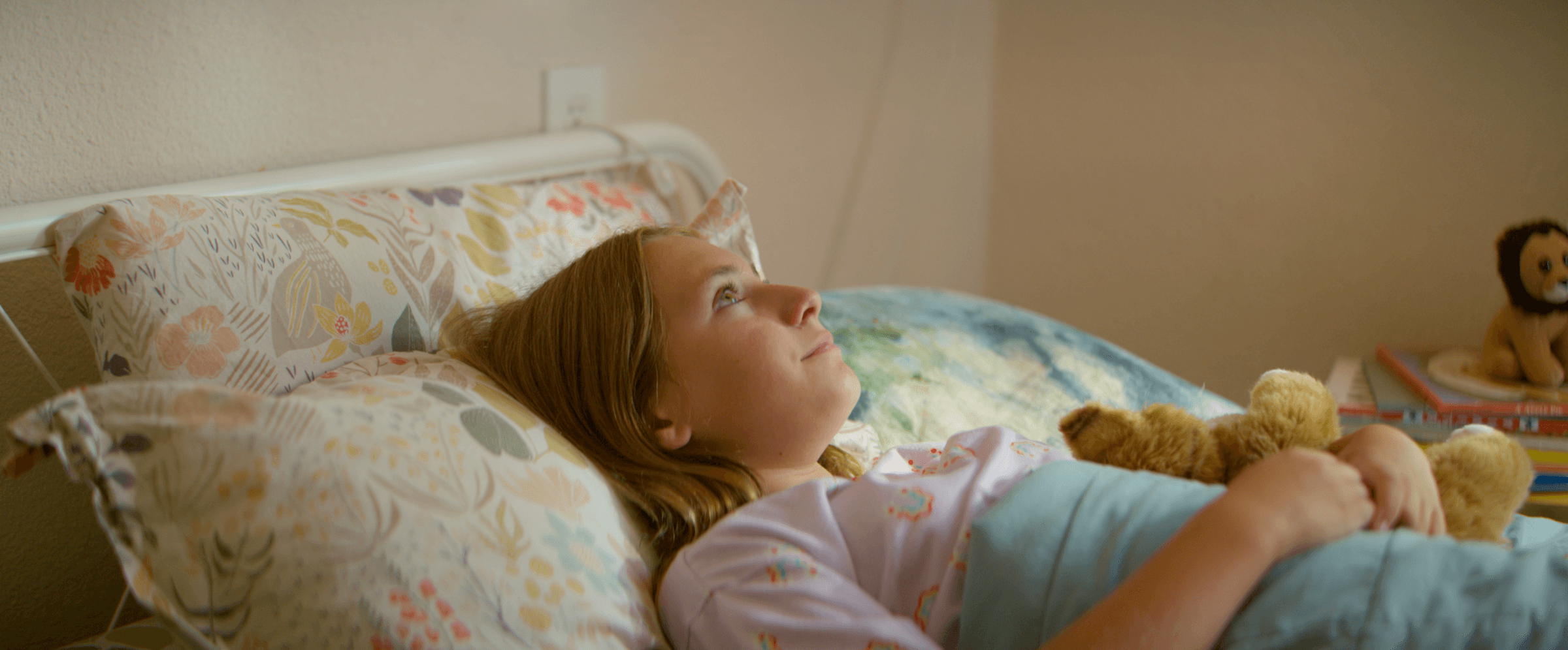 Girl lying in bed looking up